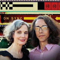 portrait of Sandra Gibson and Luis Recoder in front of background of illuminated colorful filmstrips